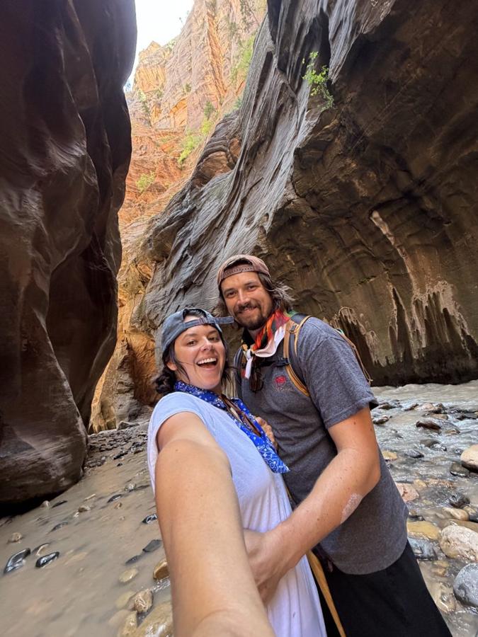 Ali and Sig taking a selfie in a slot canyon river